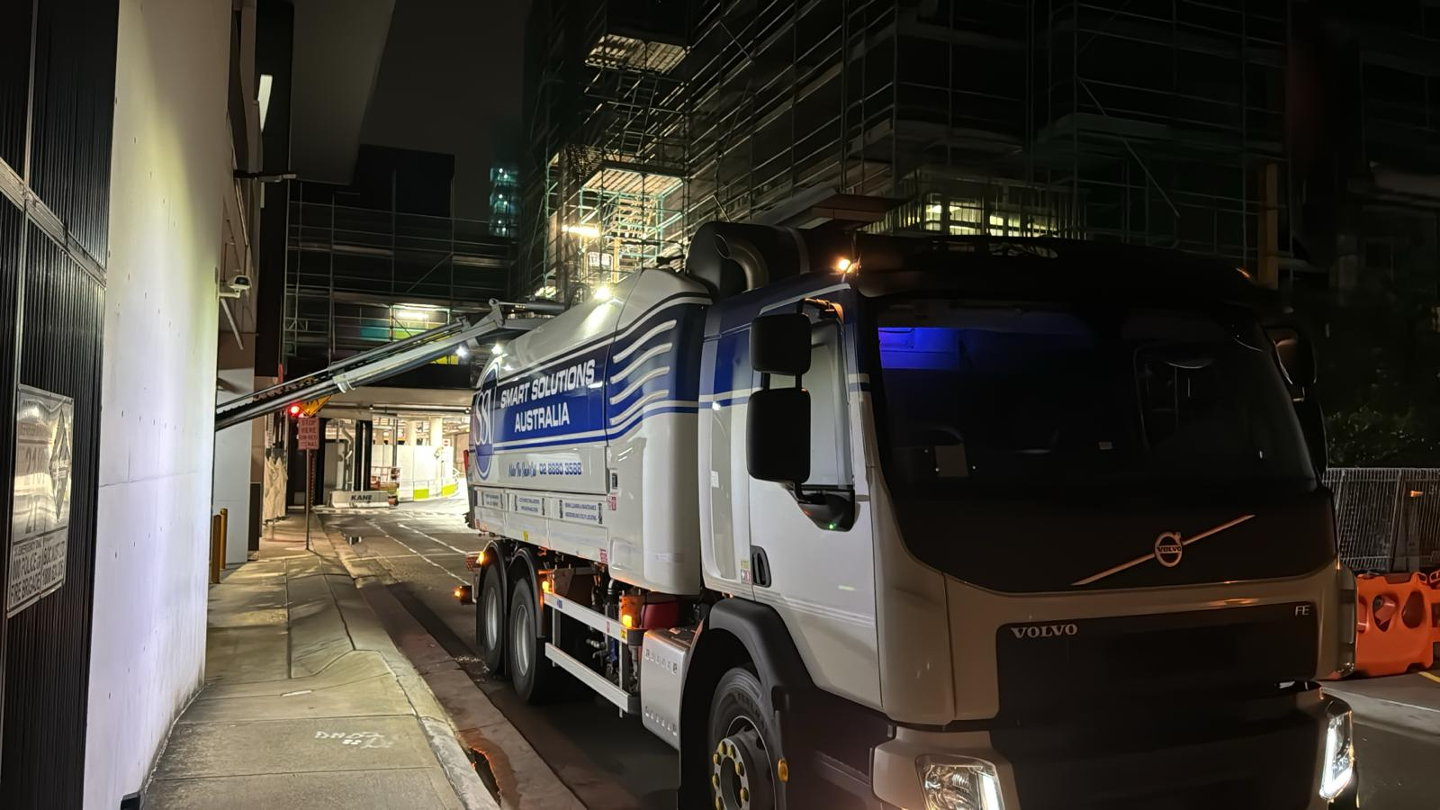 Night-shift drain maintenance in a constrained urban access lane