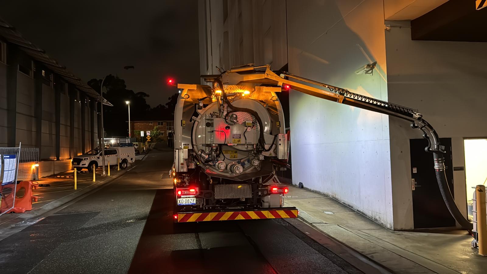 Rear boom deployed for after-hours cleaning without disrupting daytime traffic