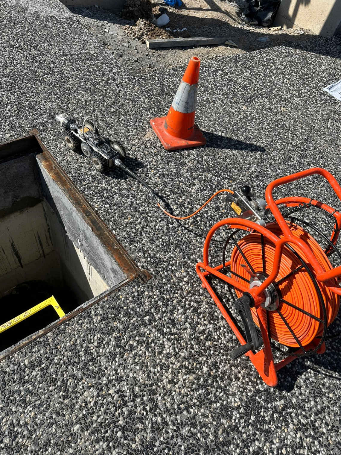 Access set up over a pit with cable reel and crawler ready to launch